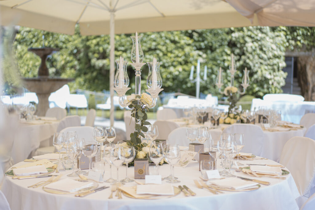 Wedding seating chart displayed in a garden courtyard during a destination wedding in Veneto