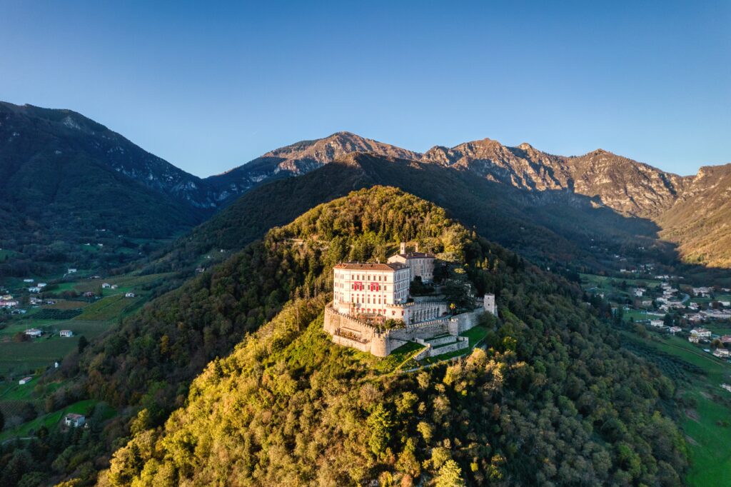 Aerial view of a majestic hilltop castle surrounded by the Veneto countryside in northern Italy
