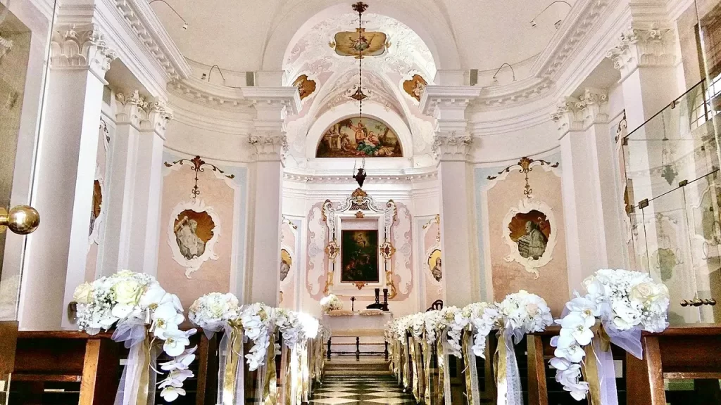 Elegant chapel decorated with white flowers for a destination wedding ceremony in Veneto, Italy