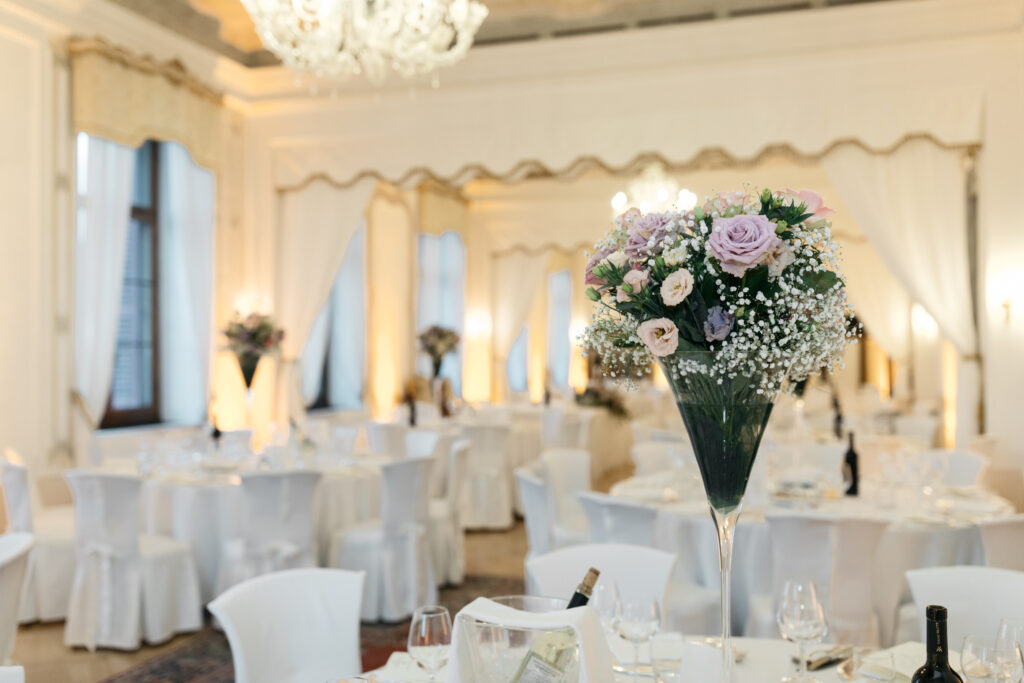 Refined buffet setup for a destination wedding reception on a terrace overlooking the Italian countryside