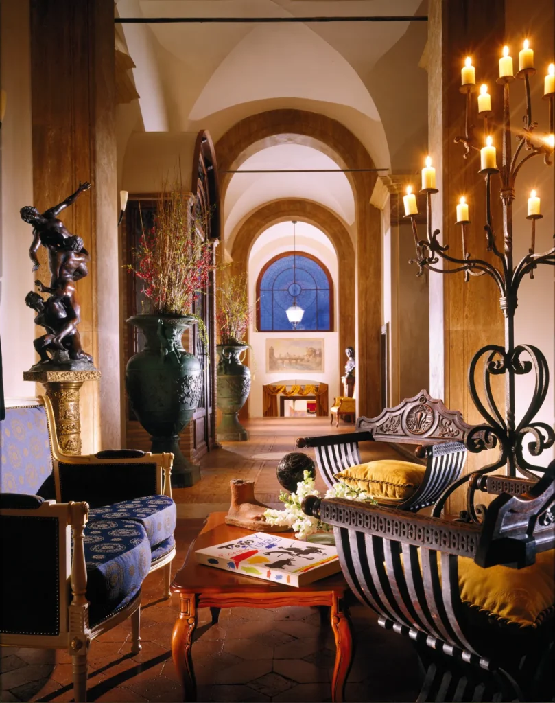 The castle lobby with arches, wrought-iron candelabra and antique furniture