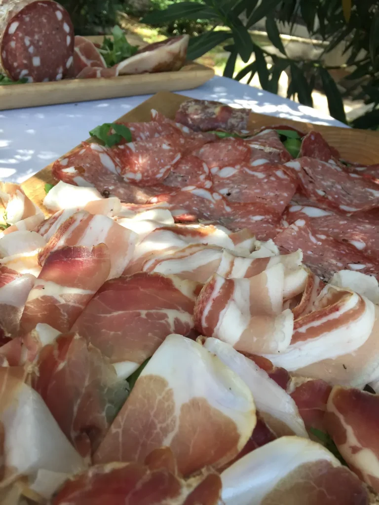 A platter of thinly sliced Italian prosciutto and cured meats