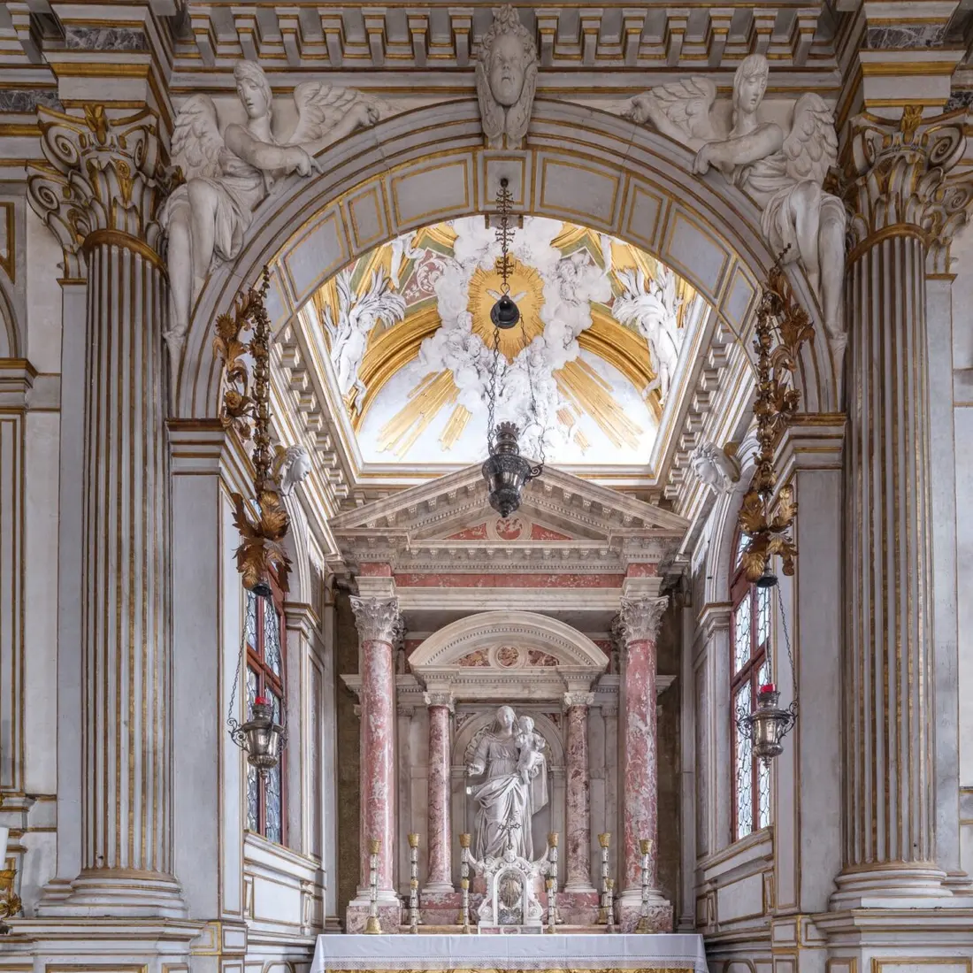 The altar of the Chapter Hall framed by marble columns and a gilded arch