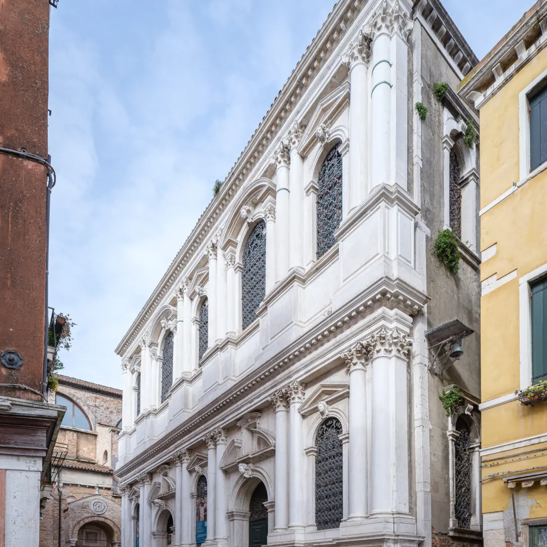 The white stone facade of the historic Venetian building on a quiet campo