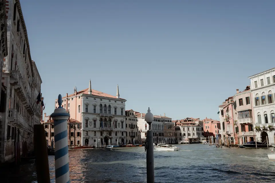 The Grand Canal on a sunny day, with mooring poles and palaces along the water