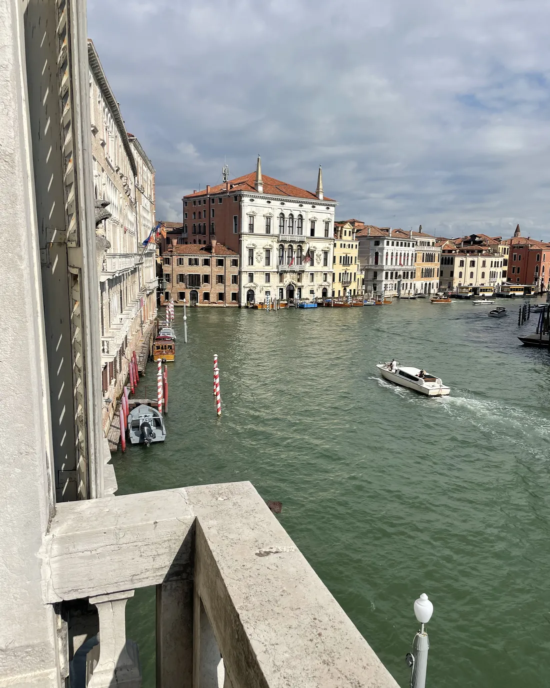 The view of the Grand Canal from the palace balcony, with boats and Venetian palaces on the other side