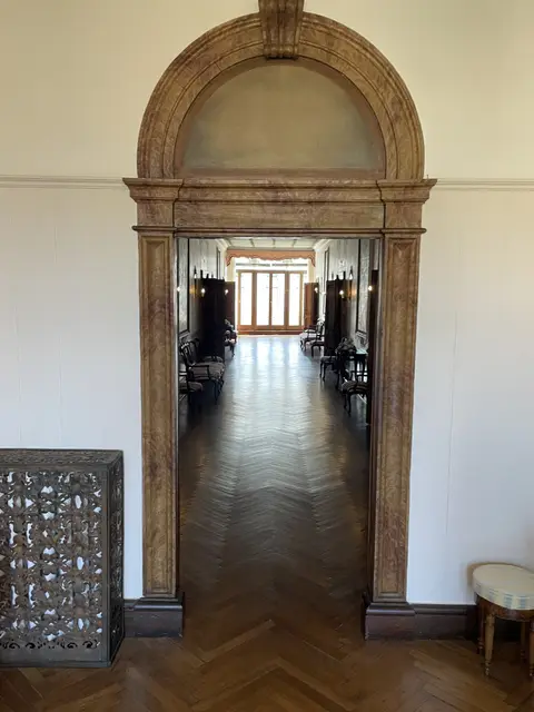 A carved stone doorway opening onto the long central hall of the noble floor