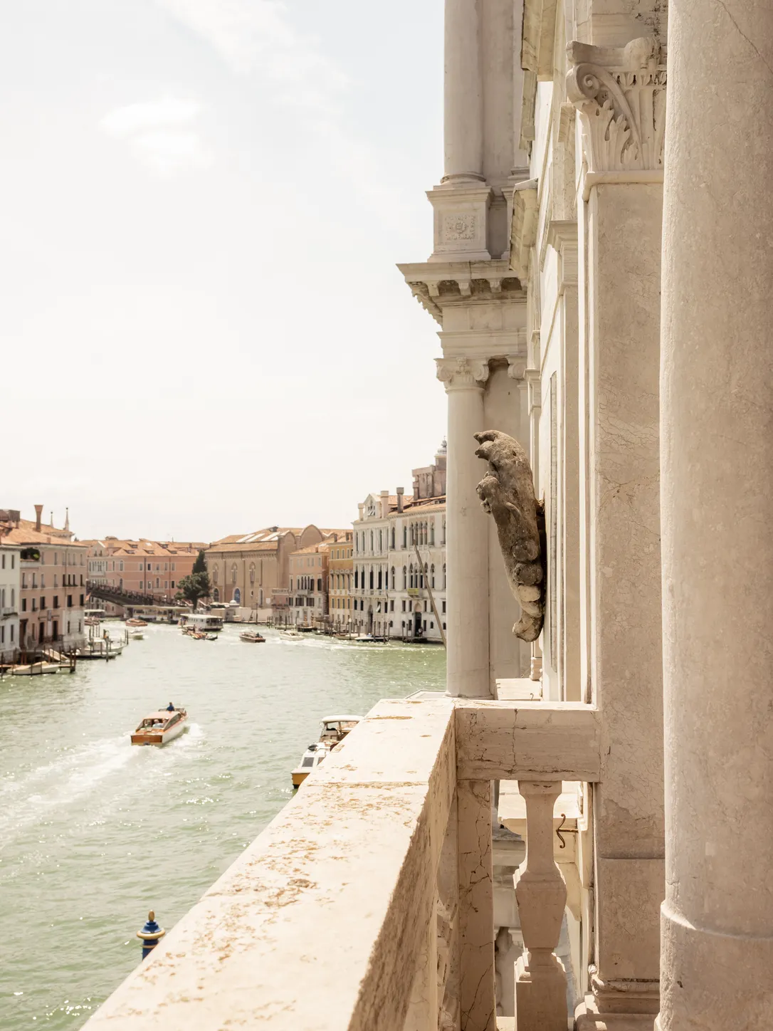 A carved stone balcony of the palace overlooking the Grand Canal and its boats