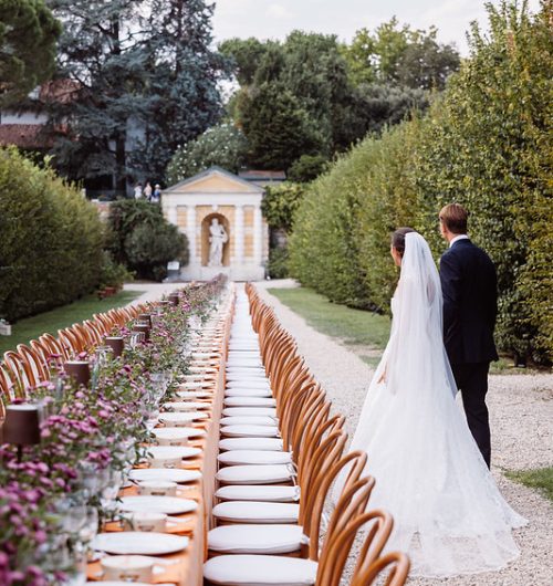 Long Banquet Table in Villa Garden with Bride and Groom